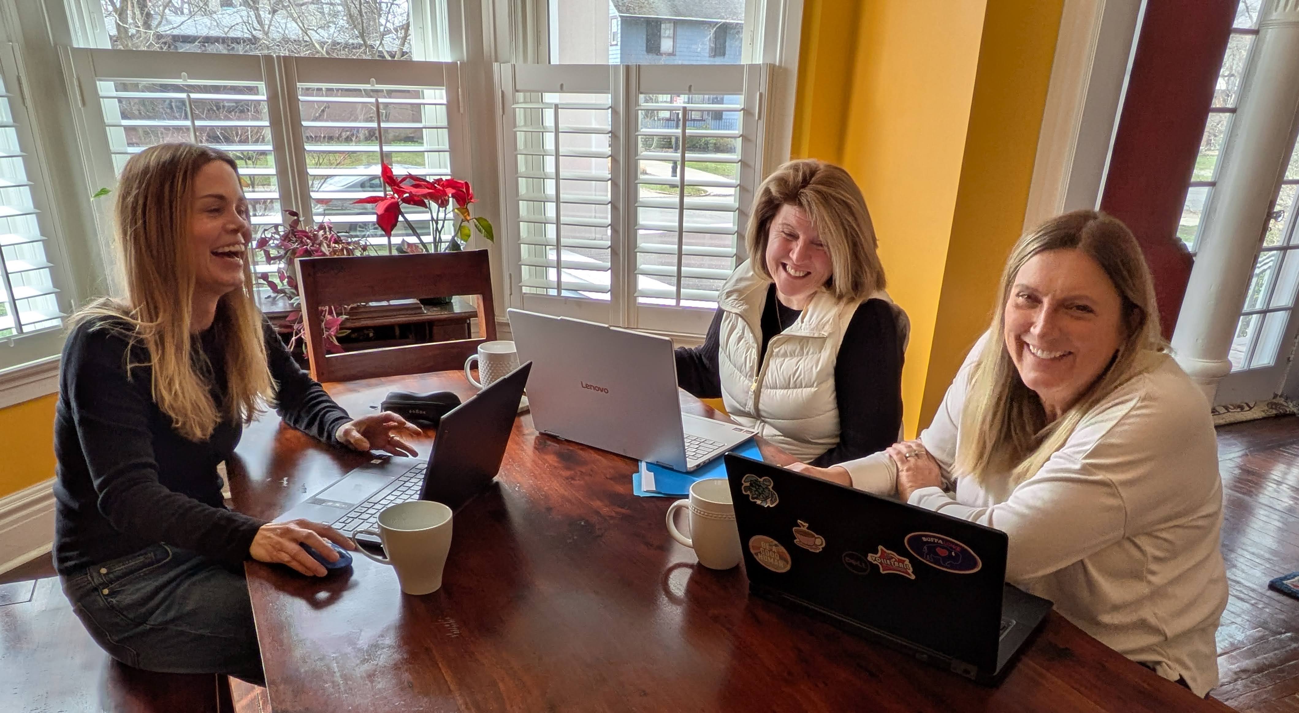 Ty, Karen and Kate work at a dining room table